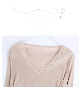 Detail of V-neck lace trim on a champagne silk thermal long sleeve top for women