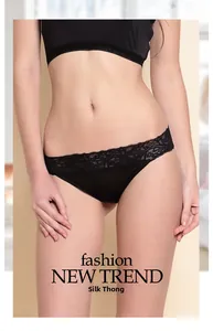 Detailed view of women's black silk thong with intricate floral lace waistband