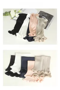 Close-up of seamless silk thermal waist warmer showing ruffled cuffs in various colors