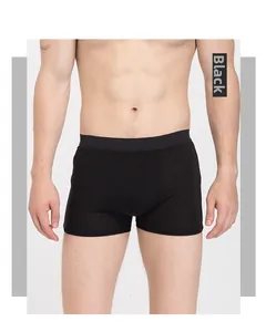 Close-up of men's black silk boxers featuring a wide elastic waistband and breathable fit