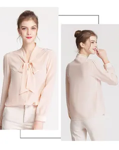 Detail of elegant silk long sleeve blouse with a pussy bow neck tie in soft nude pink