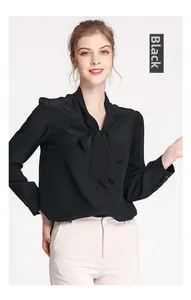 Detail of elegant black silk shirt with a large bow tie and delicate black buttons