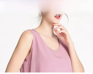 Detail view of pink silk crepe tank top showing smooth texture and round neckline