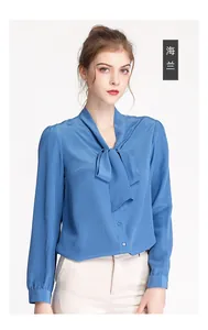Detail of silk long sleeve blouse featuring sea blue bow-knot tie and smooth texture