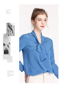 Detail of blue silk long sleeve blouse showing the elegant bow tie neck and satin texture