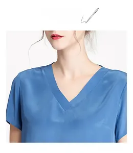 Detailed view of the V-neckline and premium silk texture on the blue summer blouse