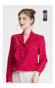 Detail of elegant wine red satin silk blouse featuring a pussy bow tie and button closure