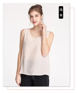 Detail of light beige silk sleeveless top with elegant round neck and premium texture