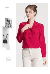 Detail of red silk blouse featuring an elegant bow tie neckline and satin finish texture