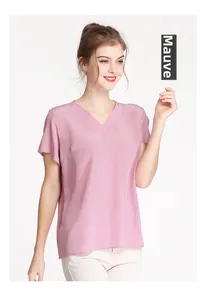 Close-up of V-neck silk blouse in dusty rose color featuring smooth crepe texture