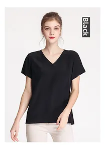 Close-up of premium black silk V-neck top showing smooth fabric texture and minimal design