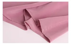 Close-up of the fine stitching and smooth hem on this dusky pink silk crepe tank top