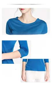 Detail view of the seamless stitching and neat hemline on a blue silk knit top