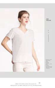 Detailed view of white V-neck silk top on model with minimalist elegant texture