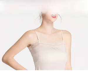 Detailed view of the delicate lace neckline and silky fabric of the beige camisole top