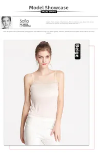 Detail of beige silk camisole with delicate lace trim and pleated neckline on model