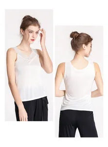 Close-up of white silk lace tank top showing elegant V-neckline and smooth fabric texture