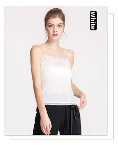 Detail of white silk camisole with delicate lace trim at neckline and hem for women
