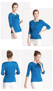Macro detail of royal blue silk knit top showing boat neck and seamless texture