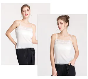 Close-up of white silk camisole featuring delicate lace trim and thin shoulder straps