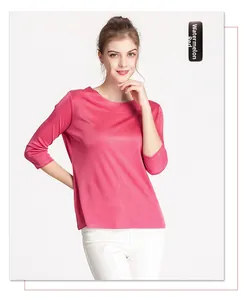 Detail of watermelon red silk knit top with boat neck and three-quarter sleeves
