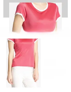 Détail du t-shirt en soie rose avec passepoil blanc contrasté et coutures de l'ourlet