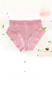 Detail of light pink silk panties featuring seamless floral lace edges and satin finish