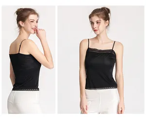 Close-up of the delicate black lace trim and silk fabric on a slim fit camisole top