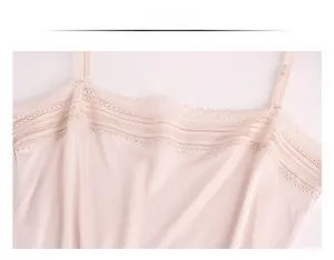 Detail of light apricot silk camisole with delicate lace trim and adjustable straps