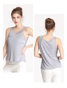 Detail view of light purple silk tank top featuring delicate lace trim and V-neckline