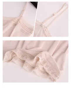 Detailed macro view of delicate lace trim and adjustable thin straps on silk camisole