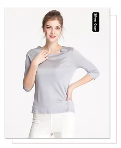 Detailed view of silver gray silk knit top with elegant boat neck and 3/4 sleeves