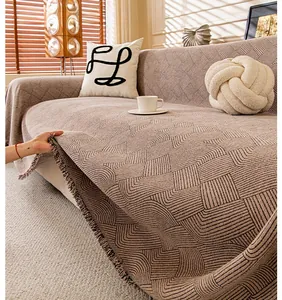 Close-up of chenille sofa cover with vintage geometric patterns and fringe edges
