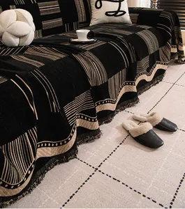 Close-up of geometric pattern chenille sofa cover with tassel fringe and thick fabric texture