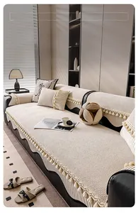 Detail of cream sofa cover with fringe tassels and decorative bow textures on fabric