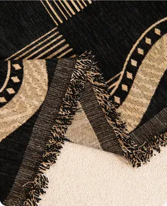 Close-up of retro chenille sofa cover showing jacquard weave texture and tassel fringe