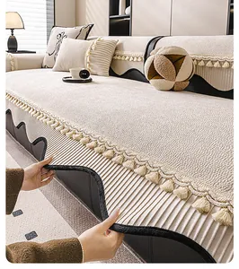 Close-up of off-white chenille sofa cover with jacquard texture and elegant fringe tassels