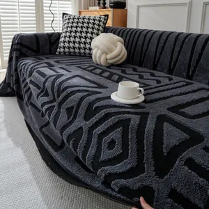 Modern grey geometric velvet sofa cover with textured diamond pattern in cozy home setting