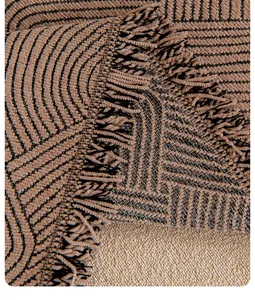 Close-up of chenille sofa cover showing geometric texture and tassel edge details