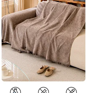 Detail of oatmeal chenille sofa cover showing woven wave texture and delicate fringe