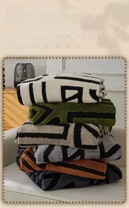 Detail of plush velvet sofa cover showing stacked multi-color geometric patterns
