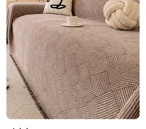 Detail of chenille fabric with black geometric wave texture and fringe on sofa cover