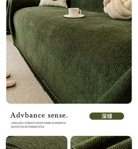 Detail of dark green chenille sofa cover with geometric texture and fringe edges