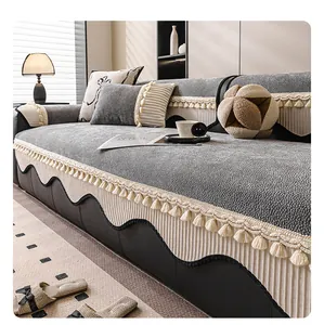 Close-up of gray chenille sofa cover with fringe detail and non-slip texture