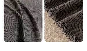 Detail of dark grey chenille waterproof sofa cover with herringbone texture and fringe