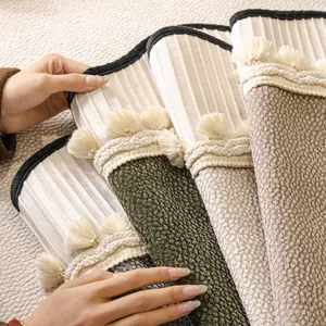 Modern anti-scratch sofa cover with tassel details in green, beige, and grey tones