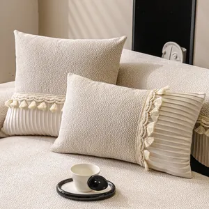 Cream chenille sofa pillow with bubble texture, pleated edges and fringe details