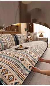 Detail of bohemian chenille sofa cover with woven geometric patterns and thick texture