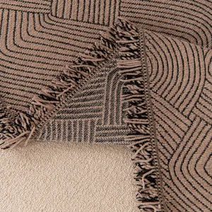 Waterproof beige chenille sofa cover with black geometric patterns and fringe edges