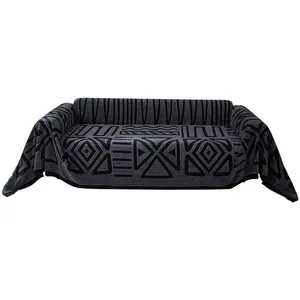 Dark grey bohemian knit sofa cover with geometric patterns on a clean white background